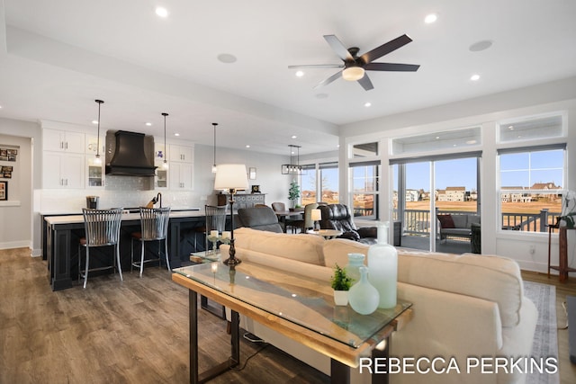 living area featuring recessed lighting, baseboards, a ceiling fan, and wood finished floors