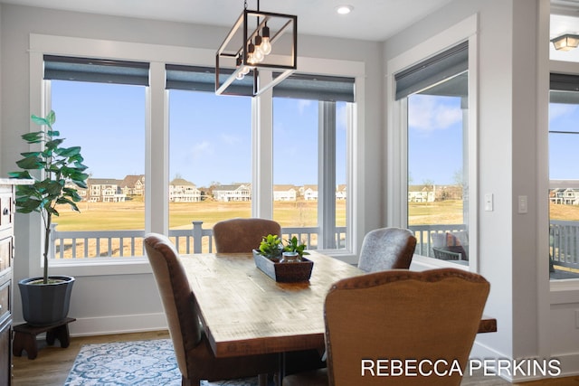 dining space featuring a notable chandelier, recessed lighting, baseboards, and wood finished floors