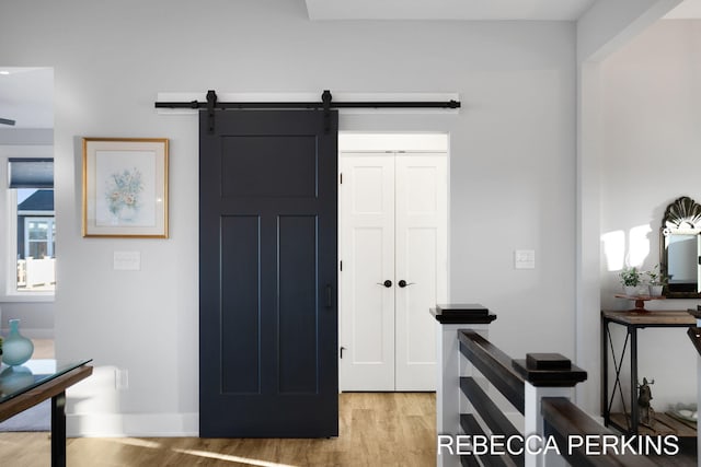 foyer featuring a barn door and light wood finished floors