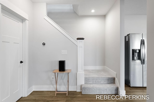 stairway with baseboards and wood finished floors