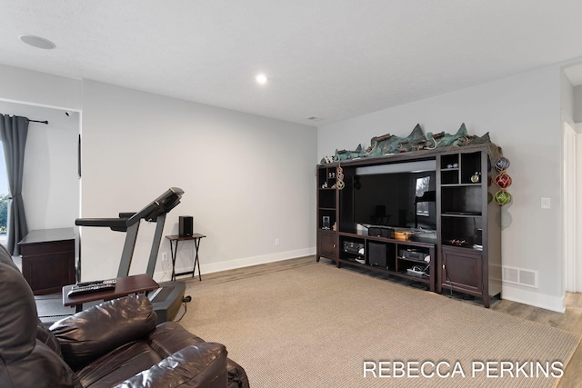 living area featuring visible vents, recessed lighting, baseboards, and wood finished floors