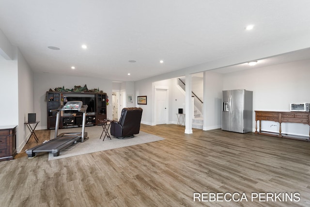 exercise area with recessed lighting and wood finished floors