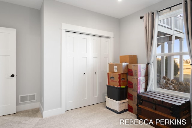 bedroom with carpet flooring, visible vents, and a closet