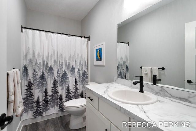 full bath with vanity, curtained shower, toilet, and wood finished floors