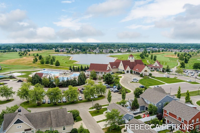 aerial view with a residential view, golf course view, and a water view