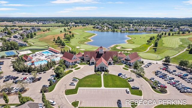 drone / aerial view featuring view of golf course and a water view