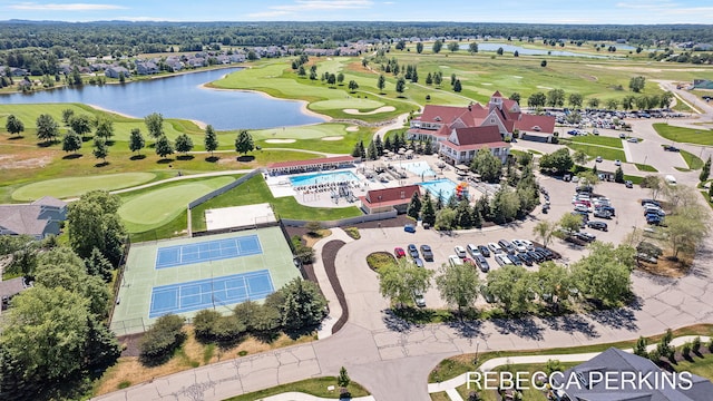 birds eye view of property with golf course view and a water view