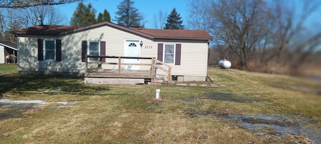 view of front of home with a deck, a front lawn, and crawl space