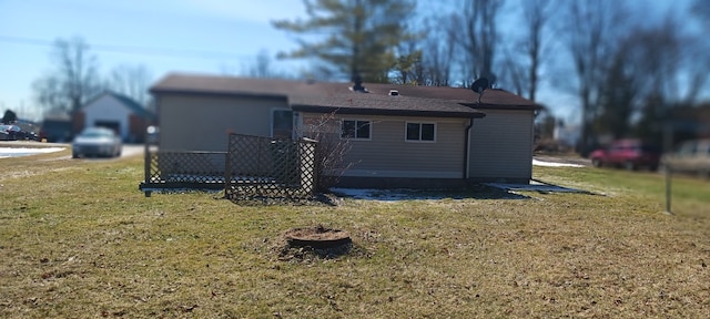 rear view of property featuring a yard