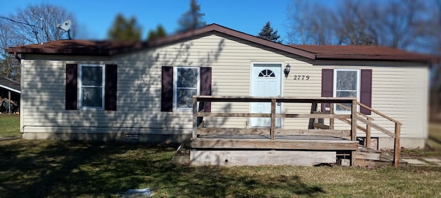 back of property featuring crawl space, a yard, and a wooden deck