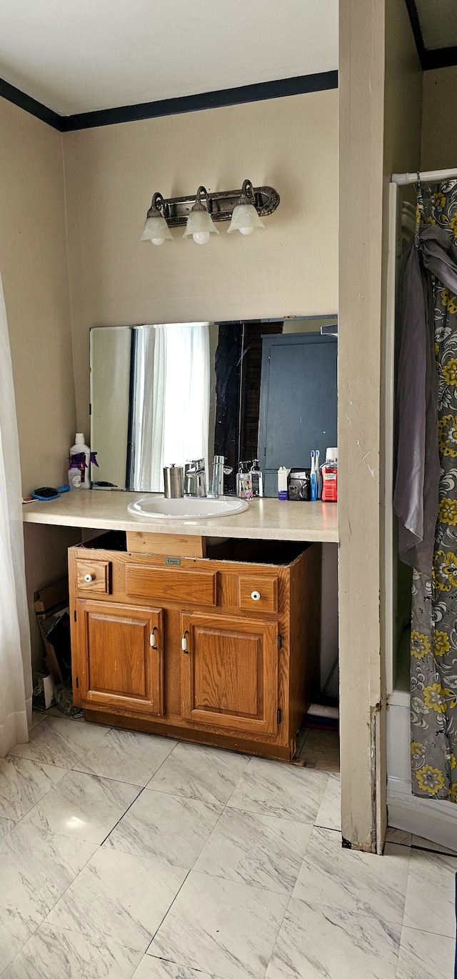 bathroom with marble finish floor and vanity