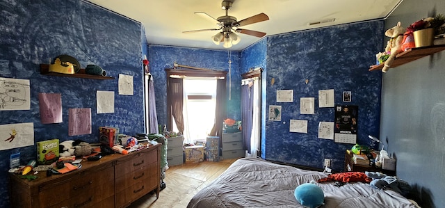 bedroom with visible vents, a ceiling fan, and wallpapered walls