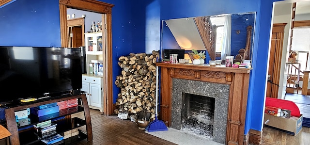 living room with wood finished floors and a fireplace