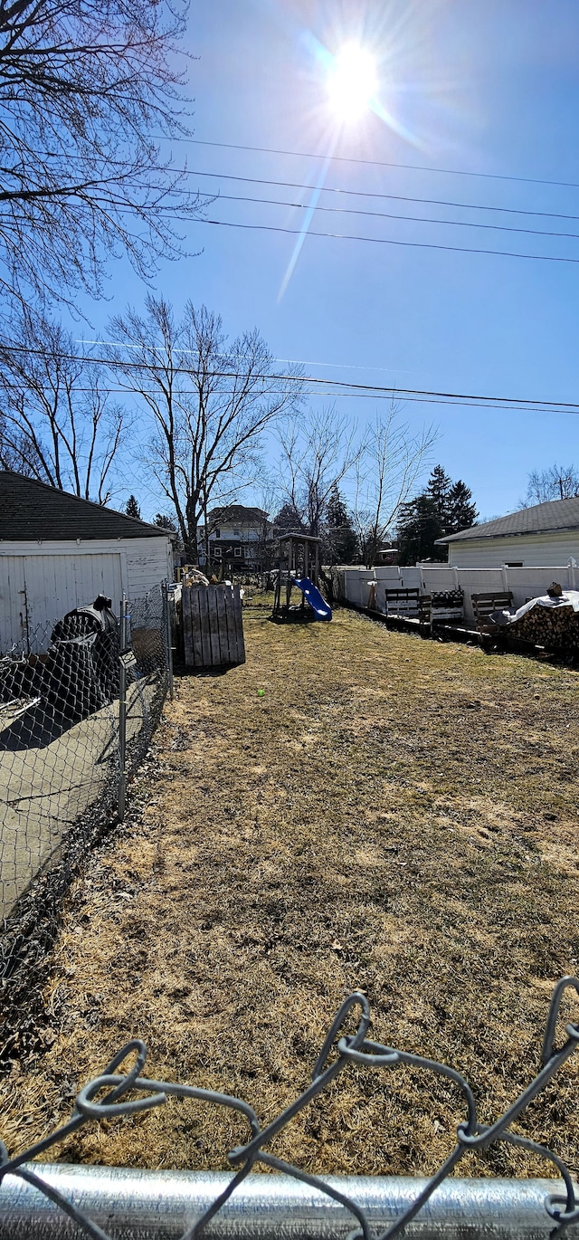 view of yard with a playground and fence