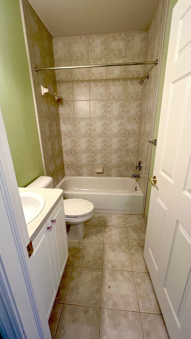 bathroom featuring vanity, tile patterned floors, toilet, and bathtub / shower combination