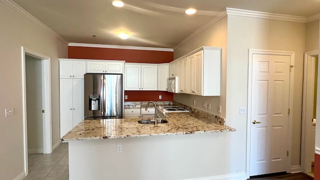 kitchen featuring white microwave, a peninsula, stainless steel refrigerator with ice dispenser, and light stone countertops