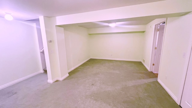 finished basement with baseboards and carpet