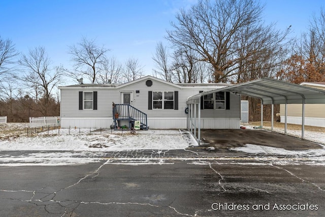 manufactured / mobile home featuring driveway and fence