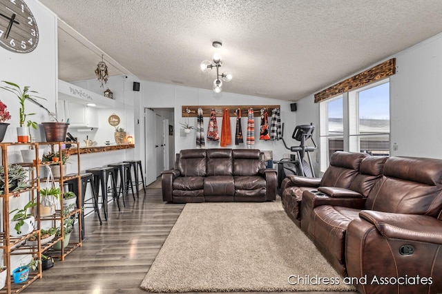 living room featuring a textured ceiling, wood finished floors, and vaulted ceiling