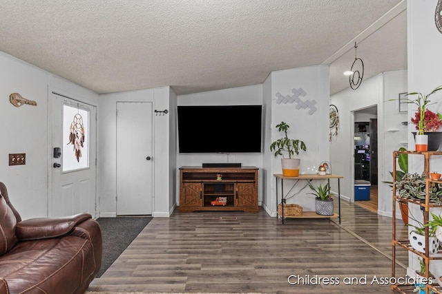 living area with a textured ceiling and wood finished floors