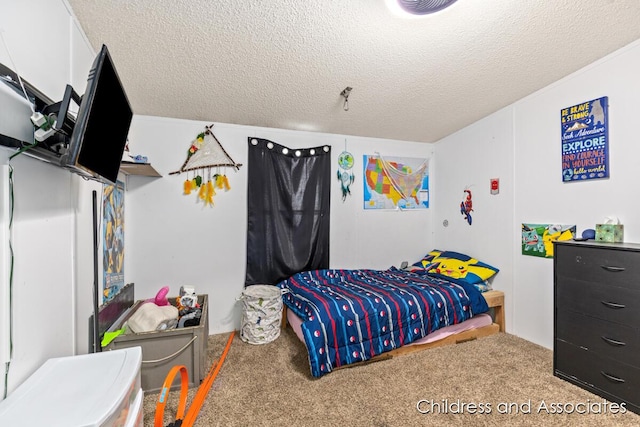 bedroom with carpet and a textured ceiling