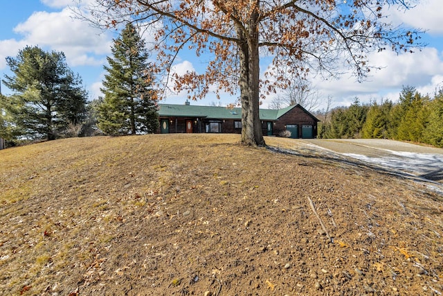 ranch-style home featuring a front yard, an attached garage, and driveway