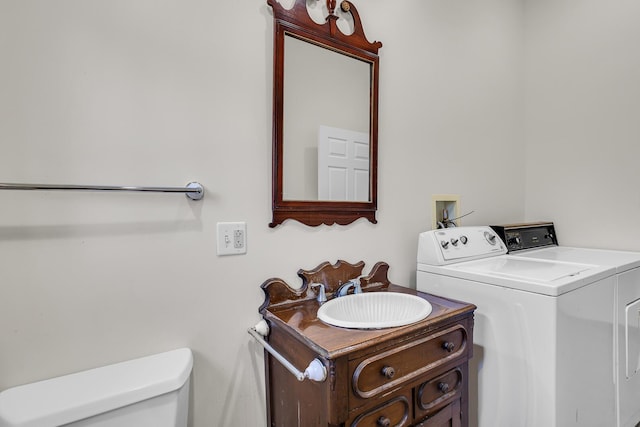 bathroom with vanity, toilet, and independent washer and dryer