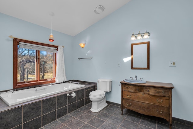 bathroom with vanity, a bath, lofted ceiling, tile patterned flooring, and toilet