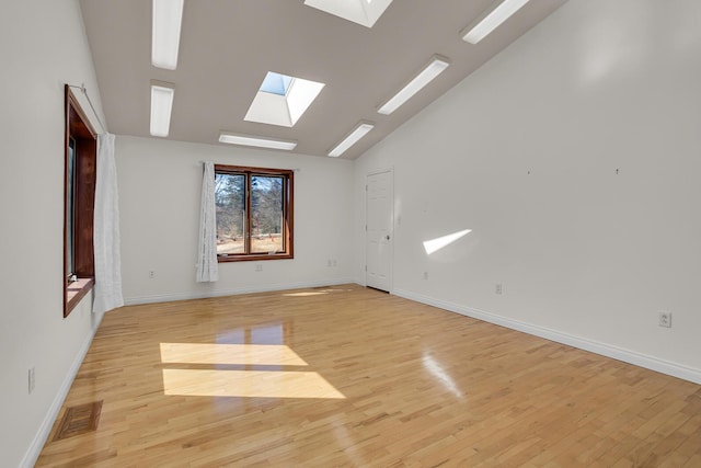 unfurnished room with visible vents, light wood-style flooring, and baseboards