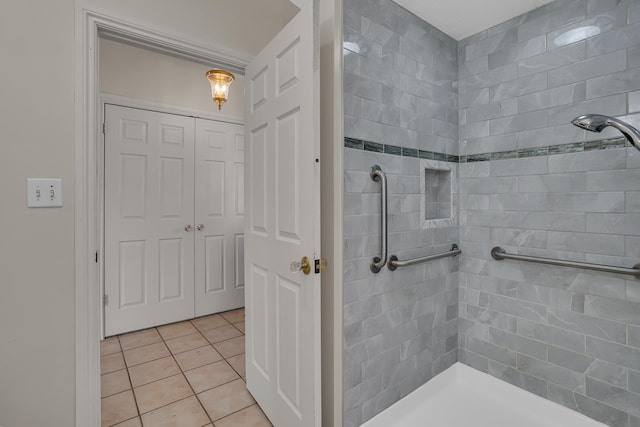 full bathroom featuring tile patterned floors and tiled shower