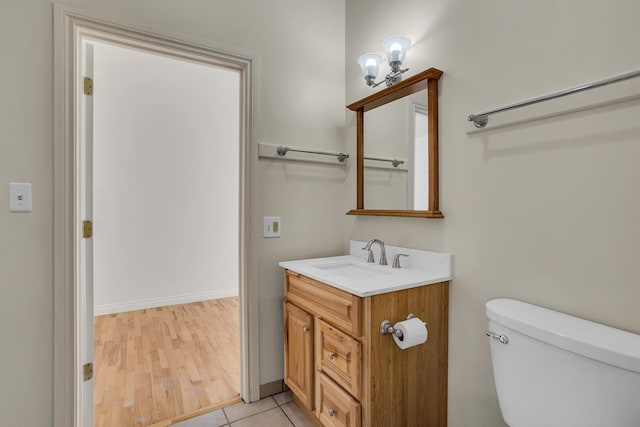 bathroom with vanity, tile patterned floors, toilet, and baseboards