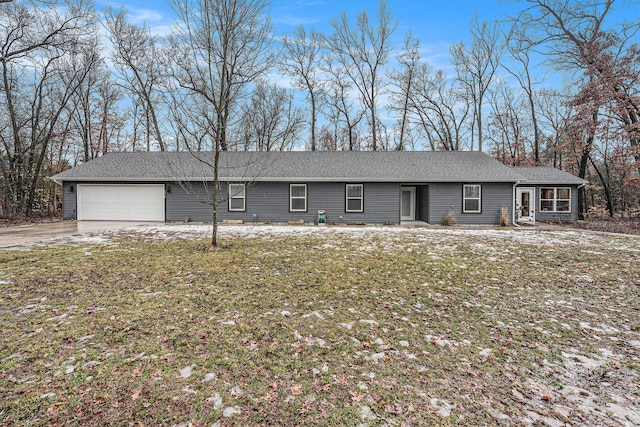 ranch-style home featuring an attached garage, driveway, and a front lawn