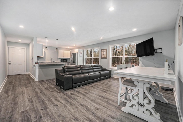 living room with baseboards, dark wood finished floors, and recessed lighting