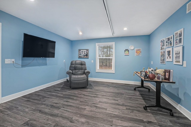 sitting room with dark wood-type flooring, baseboards, and recessed lighting