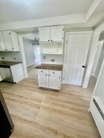 4120 Lotus Dr, Waterford, MI 48329 - kitchen with white cabinetry, dark countertops, light wood-style floors, dishwasher, and open shelves