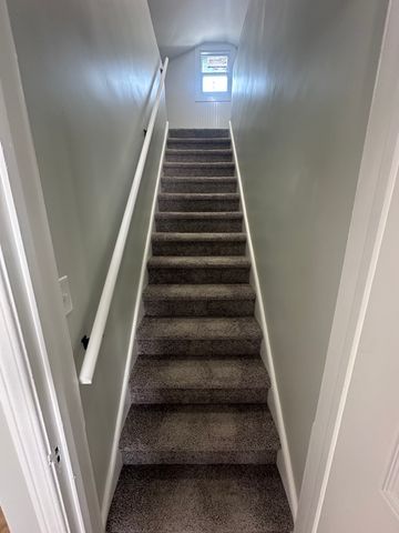4120 Lotus Dr, Waterford, MI 48329 - stairs featuring carpet floors and vaulted ceiling
