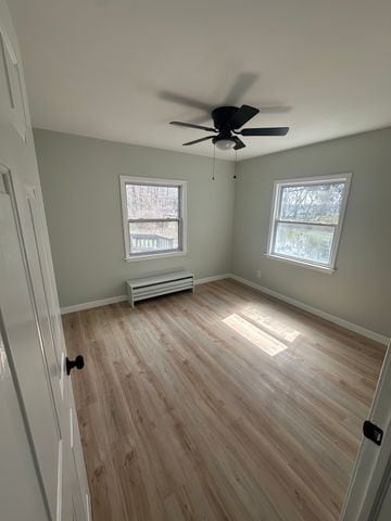 4120 Lotus Dr, Waterford, MI 48329 - unfurnished bedroom with light wood finished floors and ceiling fan