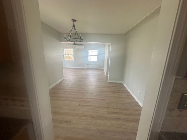 4120 Lotus Dr, Waterford, MI 48329 - unfurnished dining area with a chandelier and wood finished floors