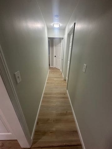 4120 Lotus Dr, Waterford, MI 48329 - corridor featuring baseboards and light wood finished floors