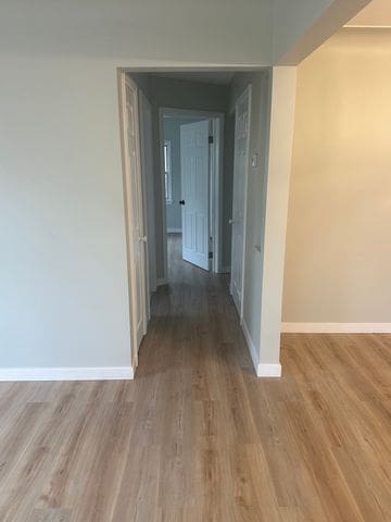 4120 Lotus Dr, Waterford, MI 48329 - hall with baseboards and wood finished floors