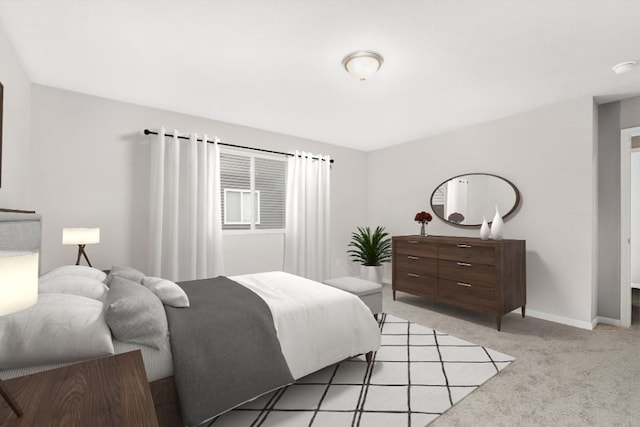 bedroom with baseboards and light carpet