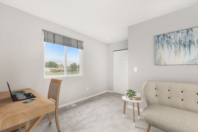 office area with visible vents, baseboards, and carpet