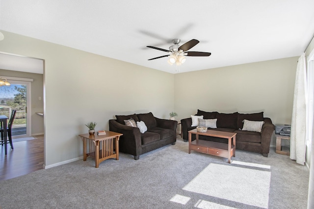 living area featuring baseboards, carpet floors, and ceiling fan