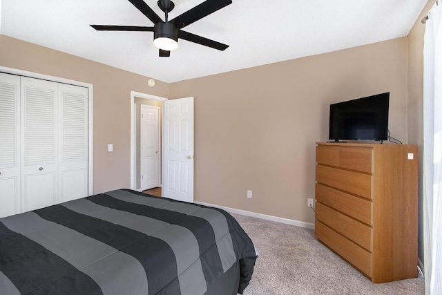 bedroom featuring light carpet, a closet, baseboards, and a ceiling fan