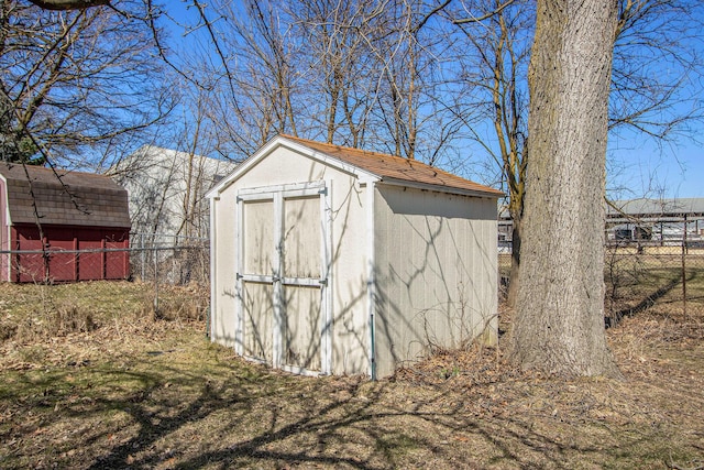 view of shed featuring fence