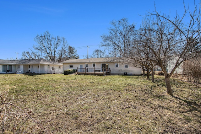 back of house with a yard and a wooden deck