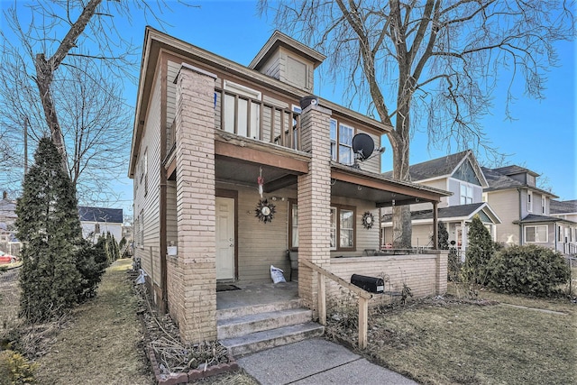 traditional style home featuring a balcony and covered porch