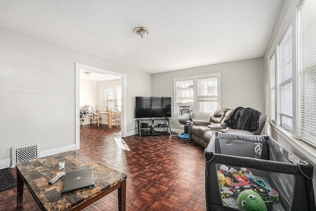 living area featuring baseboards