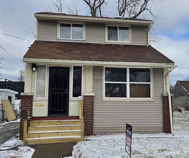 view of front facade with a shingled roof