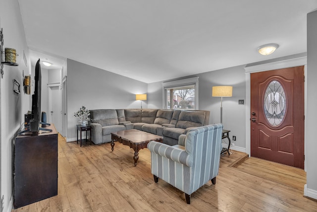 living area with light wood-style floors and baseboards